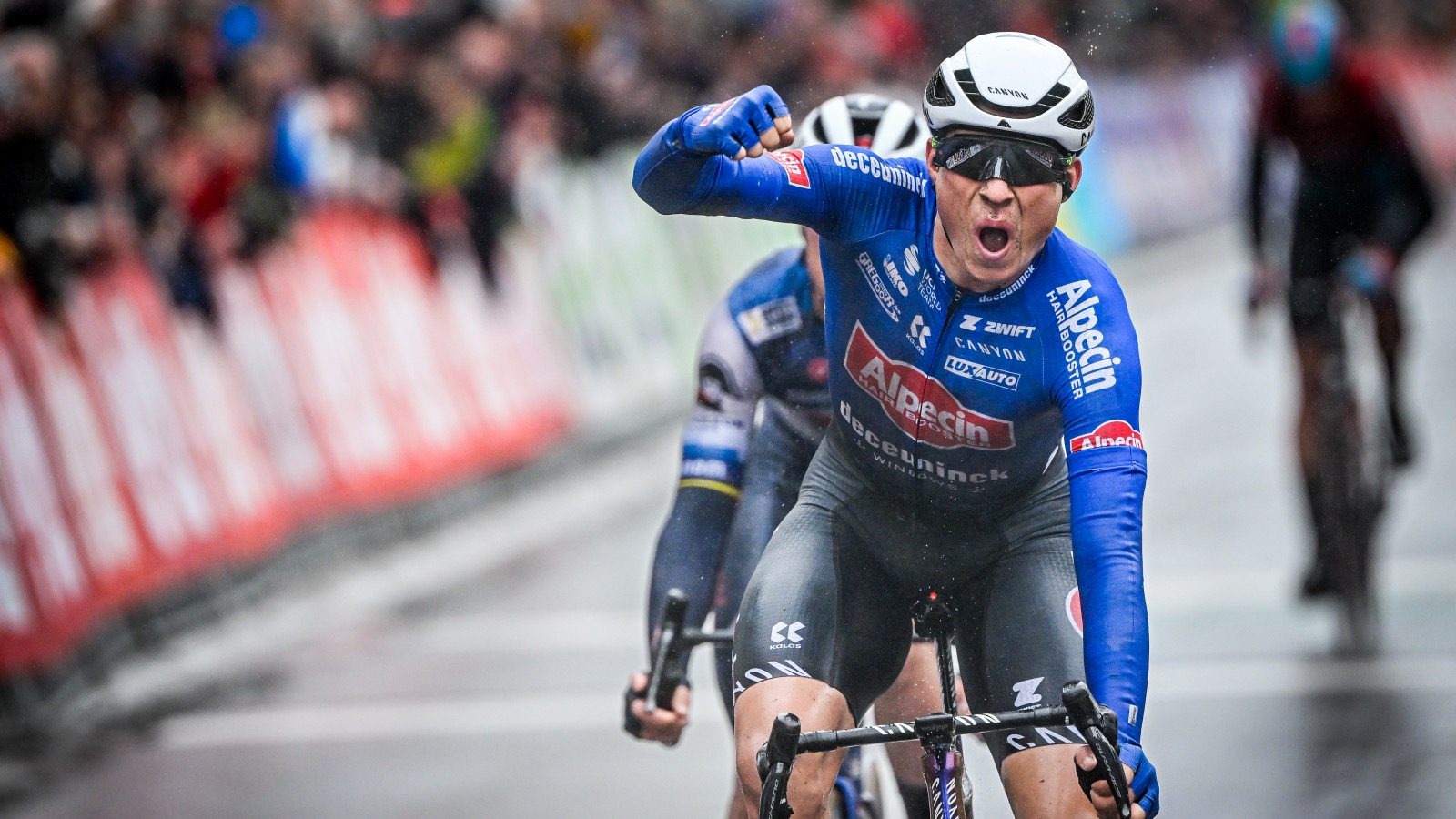 Belgian Jasper Philipsen of Alpecin-Deceuninck celebrates as he crosses the finish line to win the men's elite race of the 'Classic Brugge-De Panne' one-day cycling race, 207,4km from Brugge to De Panne, Wednesday 22 March 2023. BELGA PHOTO ERIC LALMAND